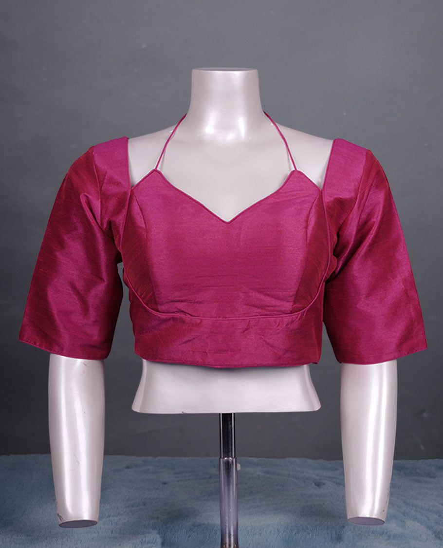 Solid Magenta colour silk padded readymade blouse with elbow-length sleeves, a V-neck front, and a deep U-back with tie-up dori.