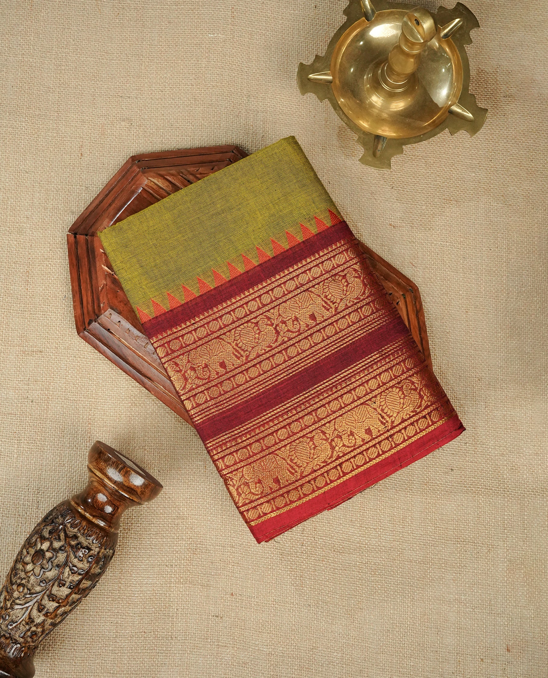 Olive colour chettinad cotton saree featuring Elegant plain body,contrast Maroon colour with Gold zari border, comes with matching blouse piece.