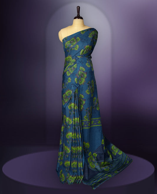 Deep Blue colour saree enhanced with a vibrant green colour floral prints on body & pallu, and  comes with a matching blouse.