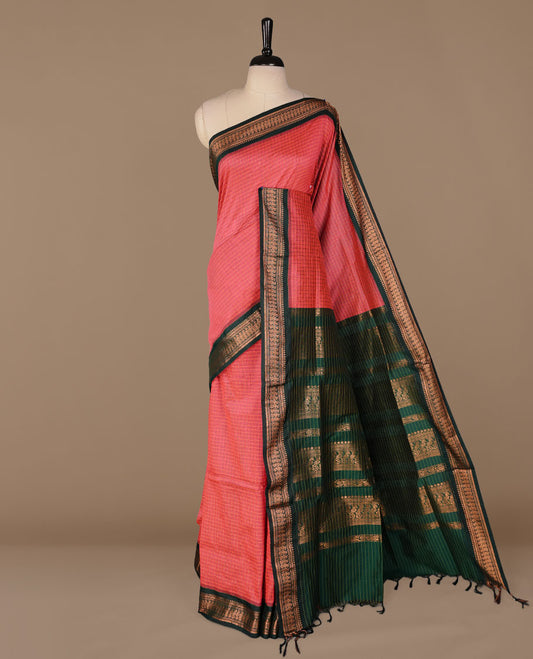 Magenta colour kalyani cotton saree featuring antique zari check pattern on body, complemented by green colour with Antique zari border, paired with matching blouse piece.