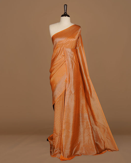 Orange colour semi banaras katan saree featuring Antique zari motifs on across body, complemented by self colour zari border, paired with matching blouse piece.