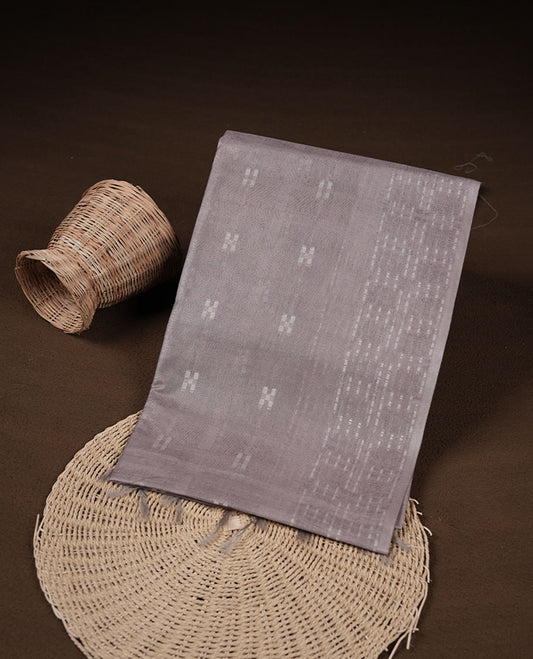 Gray colour semi jute saree highlighting white thread motifs on body, without border and paired with matching blouse.