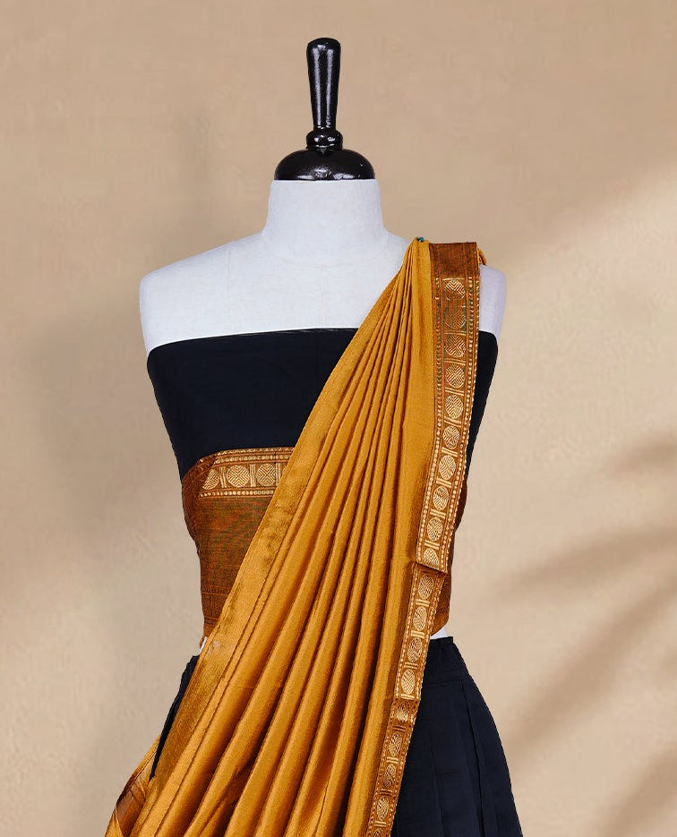 Black colour Half saree featuring Plain skirt with Zari border on contrast Mustard colour border, Unstitched Blouse and matching dupatta.
