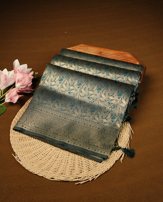 Teal Blue  Colour Softie Silk Saree Featuring An All Over Gold Woven Leaf Pattern, Finished With A Matching Border Adorned With Intricate Paisley And Floral Motifs, Paired With A Matching Blouse Piece.