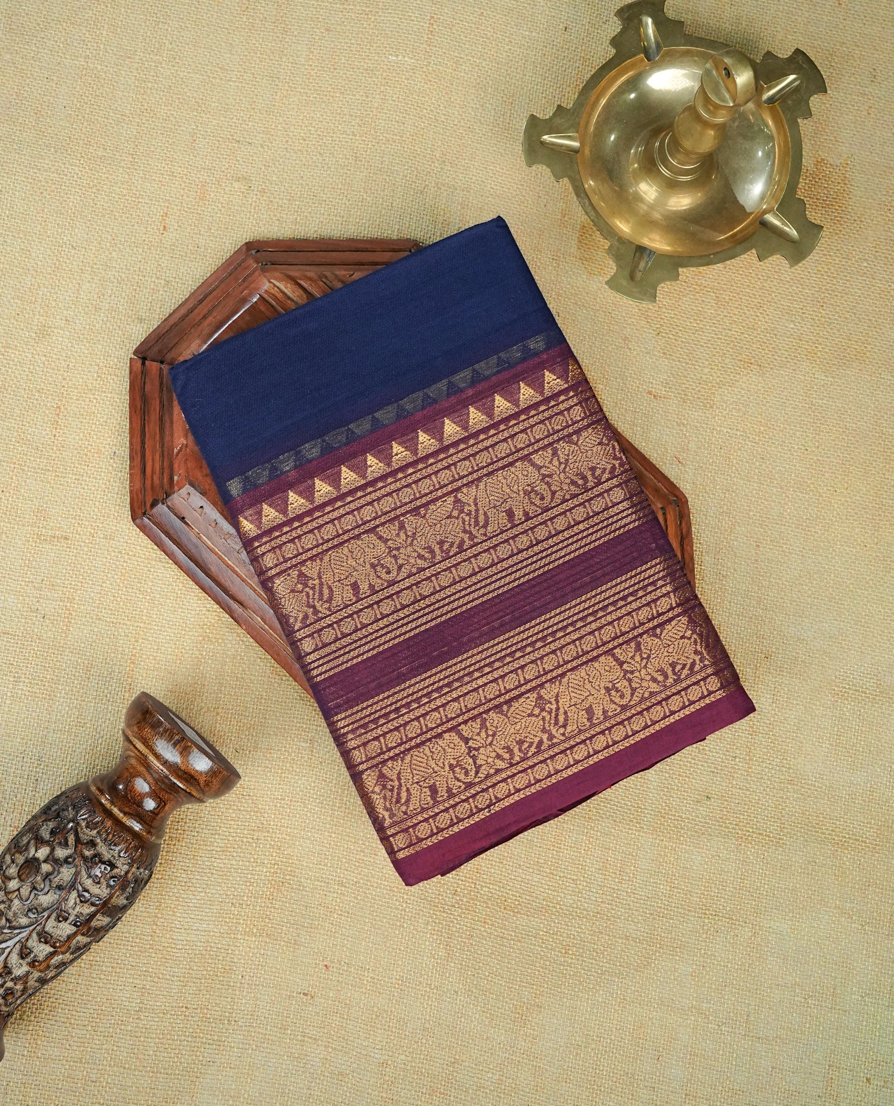 Navy blue colour chettinad cotton saree featuring elegant plain body, complemented by contrast Maroon colour with gold zari border,comes with matching blouse piece.