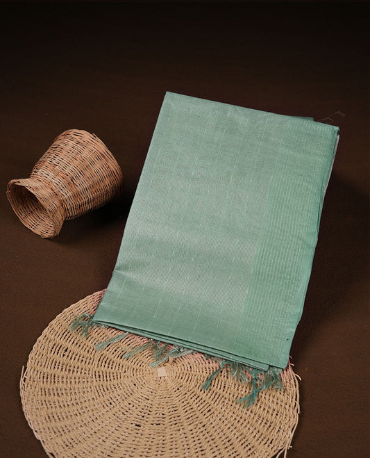 Mint colour semi jute saree highlighting gold zari striped body, without border and paired with matching blouse.