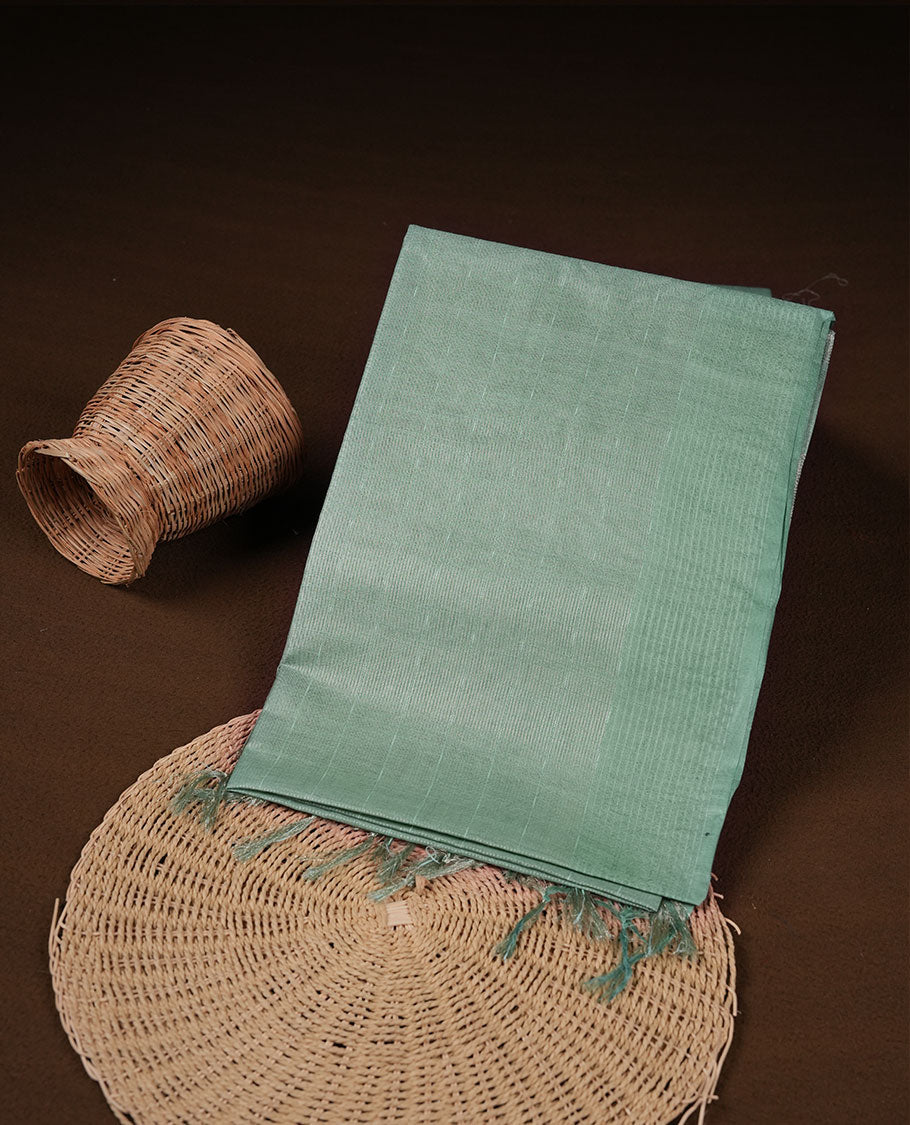 Mint colour semi jute saree highlighting gold zari striped body, without border and paired with matching blouse.
