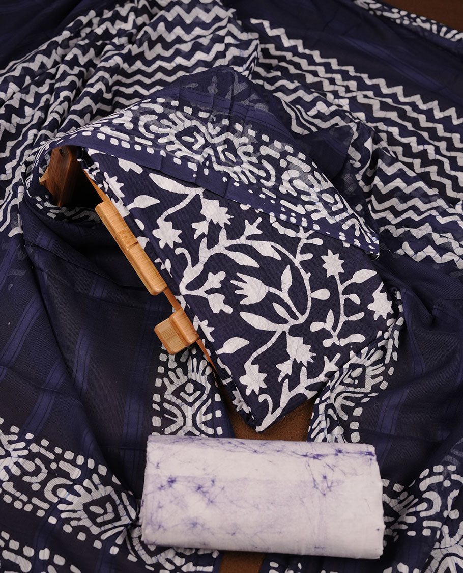 Navy Blue colour churidar material featuring white floral printed body, paired with a matching chevron printed dupatta.