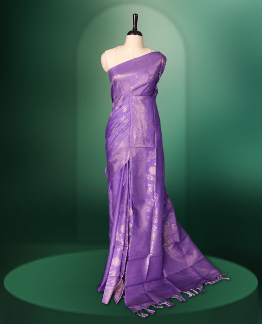Lavender colour saree featuring subtle woven floral motifs with a lustrous finish, complemented by delicate tassels on the pallu, and paired with a matching blouse