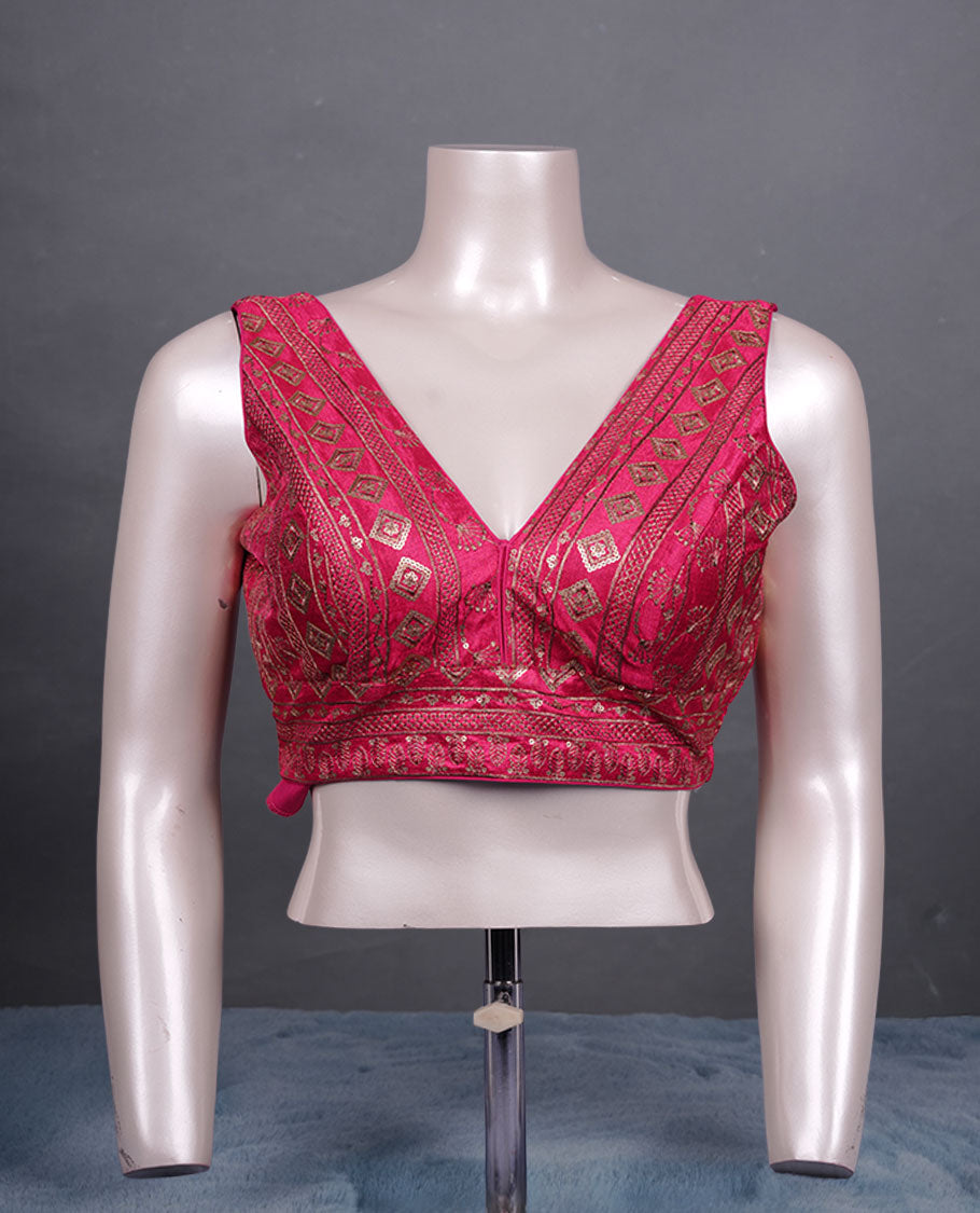 Pink colour embroidered sleeveless blouse with intricate geometric motifs, deep V neckline, and tie-up back detailing for a chic finish.