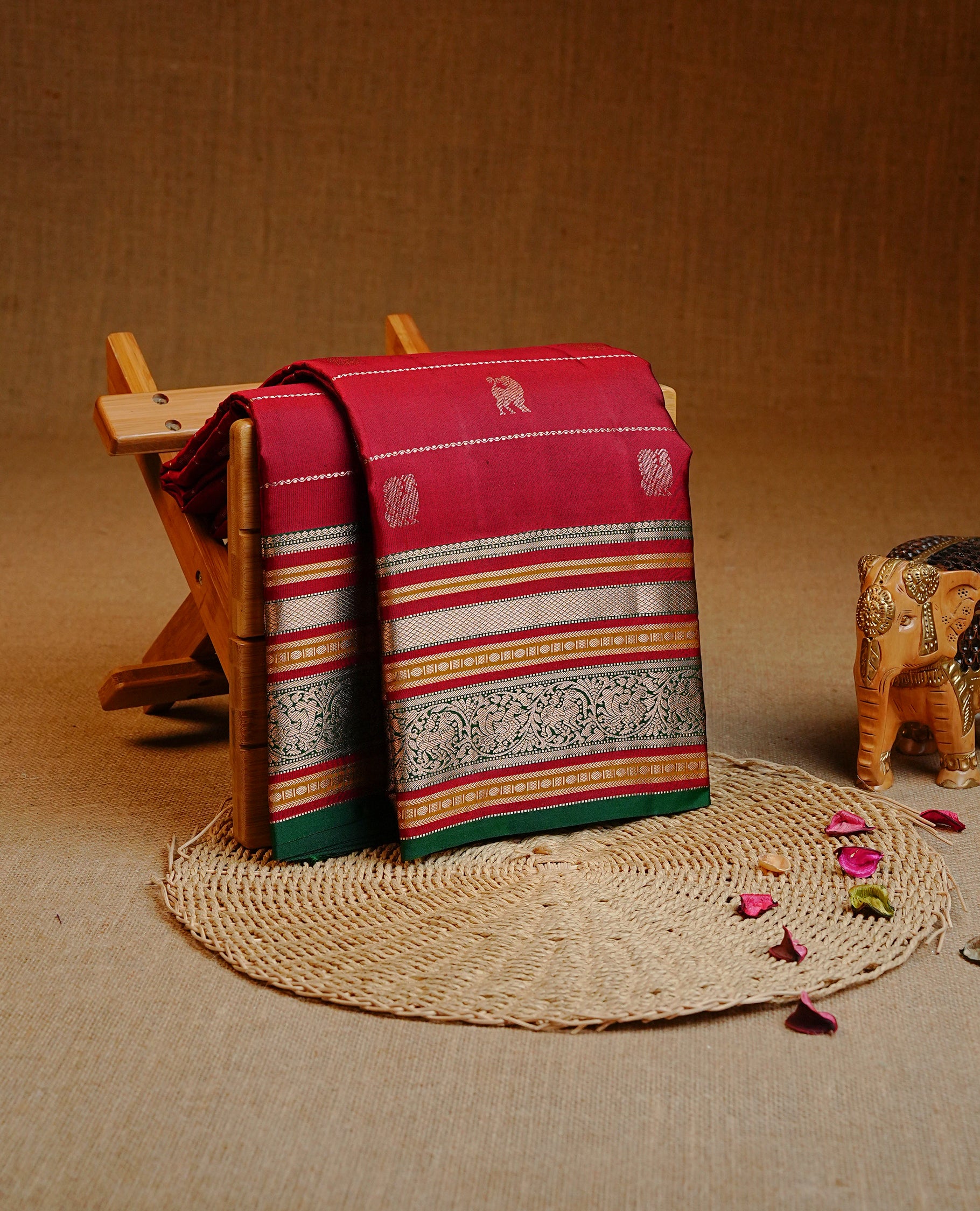 Maroon colour Kancheepuram silk saree featuring Gold Zari Peacock & stripes on body, enrich Gold Zari with Red, mustard on contrast Green border, paired with a Matching blouse piece.