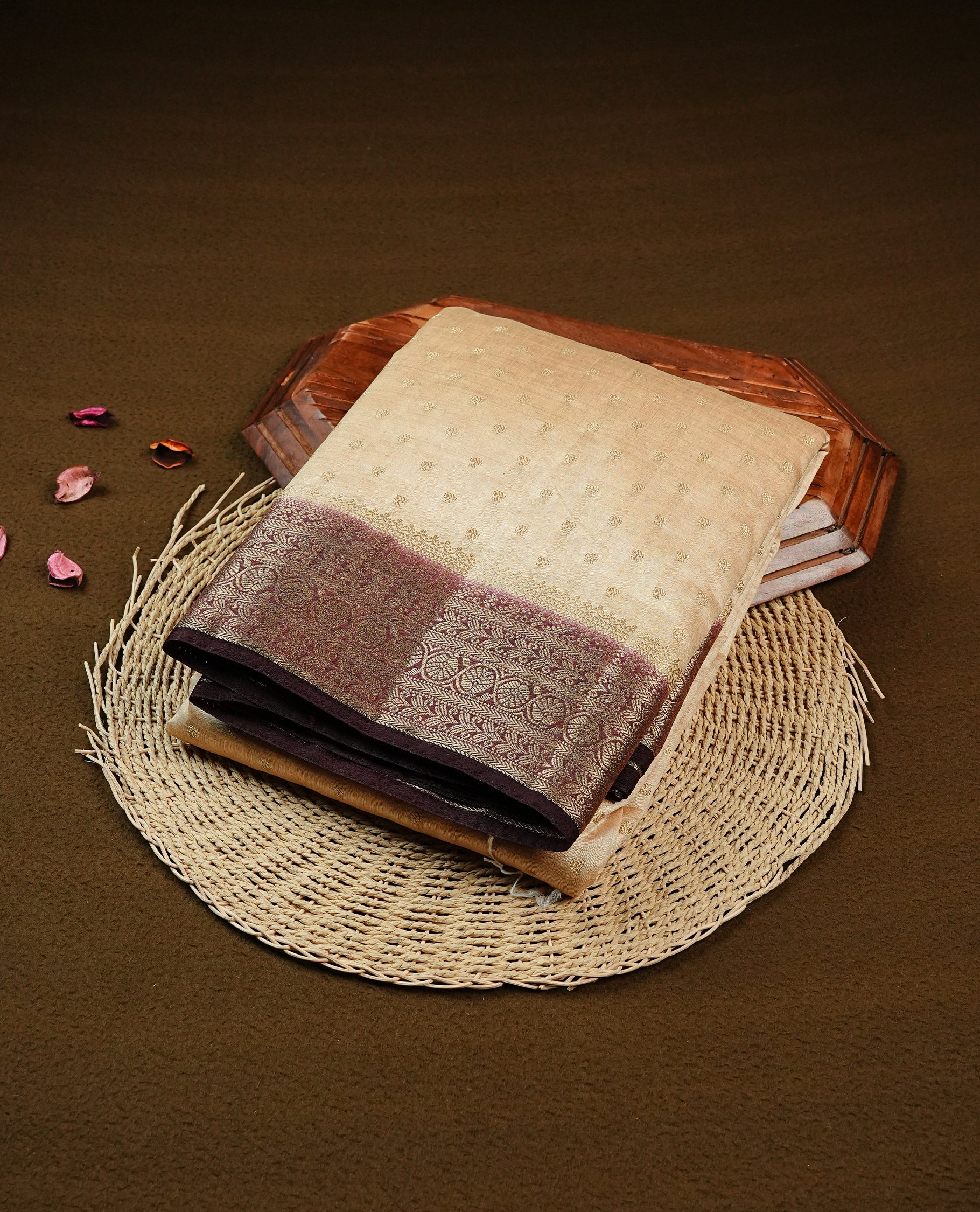 Cream colour Semi Tussar silk saree featuring an Gold zari motifs on body, accentuated by a contrast Chocolate brown border adorned with intricate gold zari work, paired with a matching blouse piece.