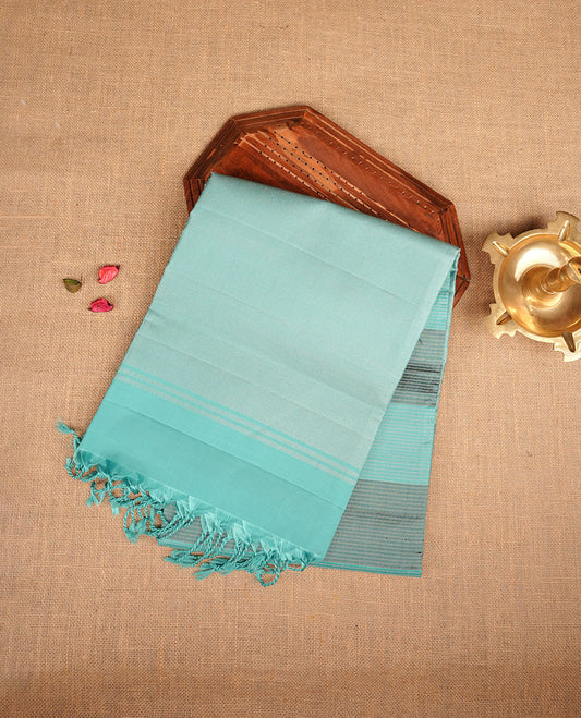 Aqua & grey colour soft silk saree featuring gold zari stripes on body, complemented by self colour border and tassel at pallu, paired with matching blouse piece.