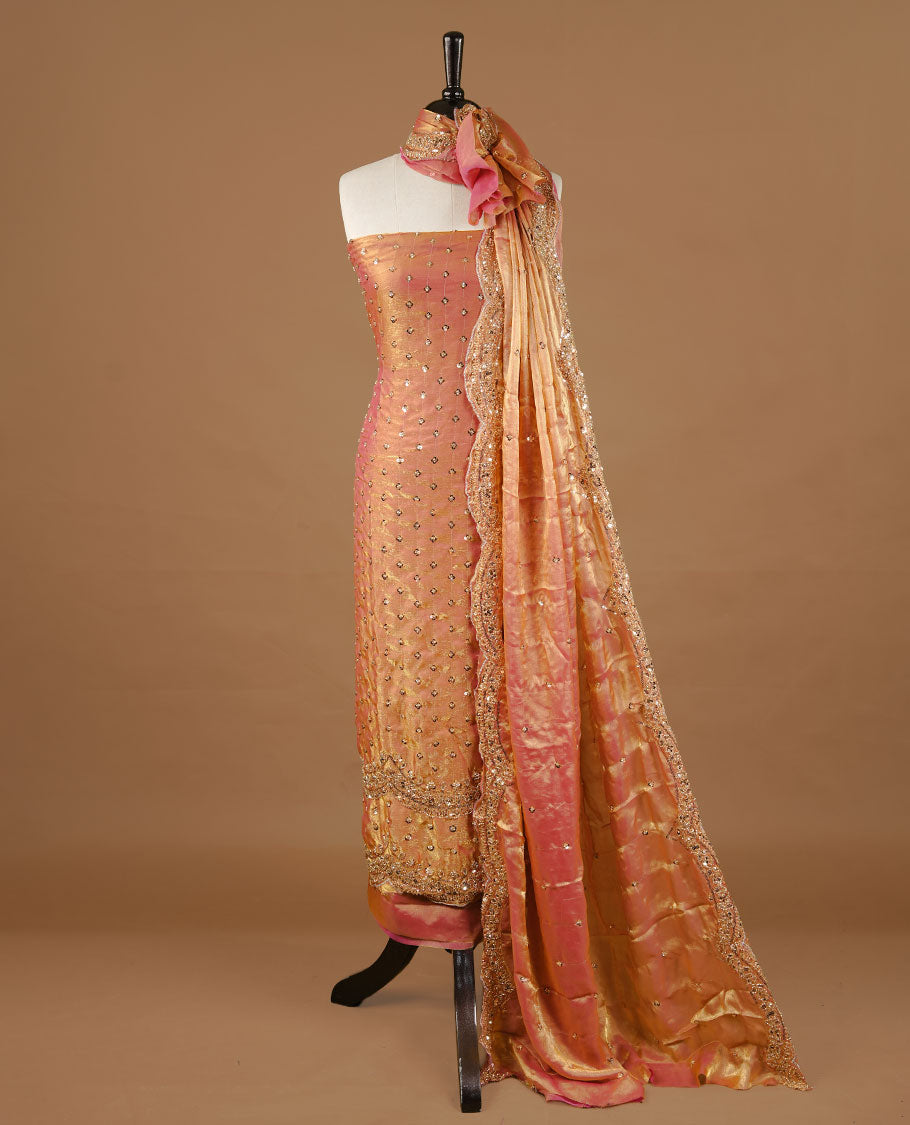 Peach colour churidhar material featuring cut beads and sequins work on the body, paired with a matching unstitched bottom and worked dupatta.