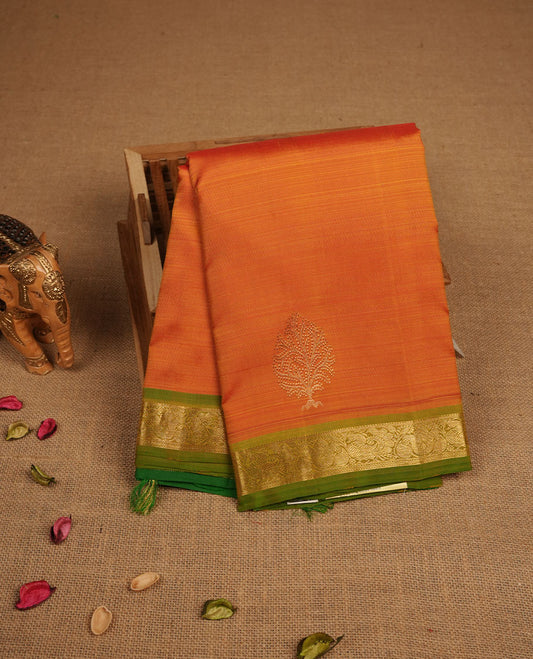 Mustard yellow pure traditional Kancheepuram silk saree adorned with gold zari motifs across the body, featuring elegant and simple contrast light green zari traditional borders, beautifully paired with a matching blouse piece.