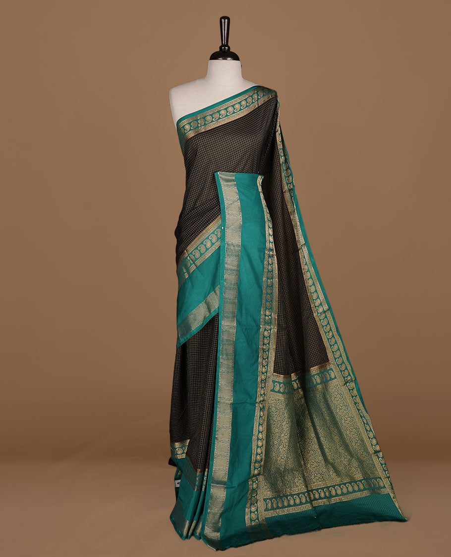 Black colour semi georgette saree featuring gold zari check pattern on body, complemented by contrast green colour with zari border, paired with matching blouse piece.