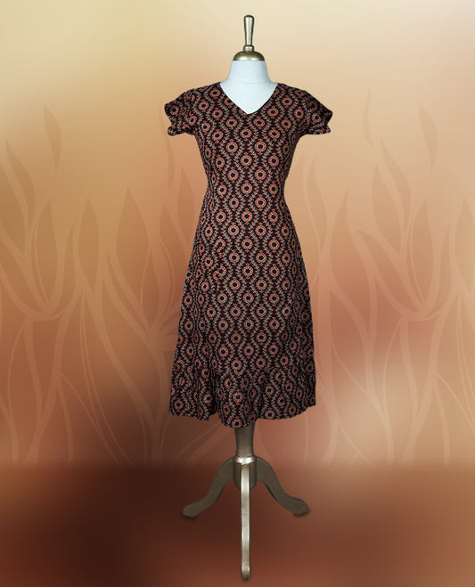 Brownish black colour nightwear with an elegant red and beige ethnic print, Features a flattering V neck, short sleeves, and a flared hem, Ideal for casual outings, festive gatherings, or comfortable daily wear.