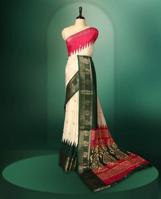 Off white colour saree with delicate golden motifs, highlighted by a striking pink upper border, rich green zari woven border, and a contrasting red and green pallu with intricate floral and geometric designs, paired with a matching blouse