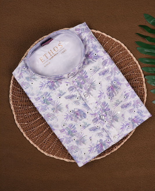 White cotton kurta adorned with subtle floral prints in shades of purple and blue, featuring a mandarin collar, buttoned placket, and full sleeves, designed for festive and semi-formal occasions.