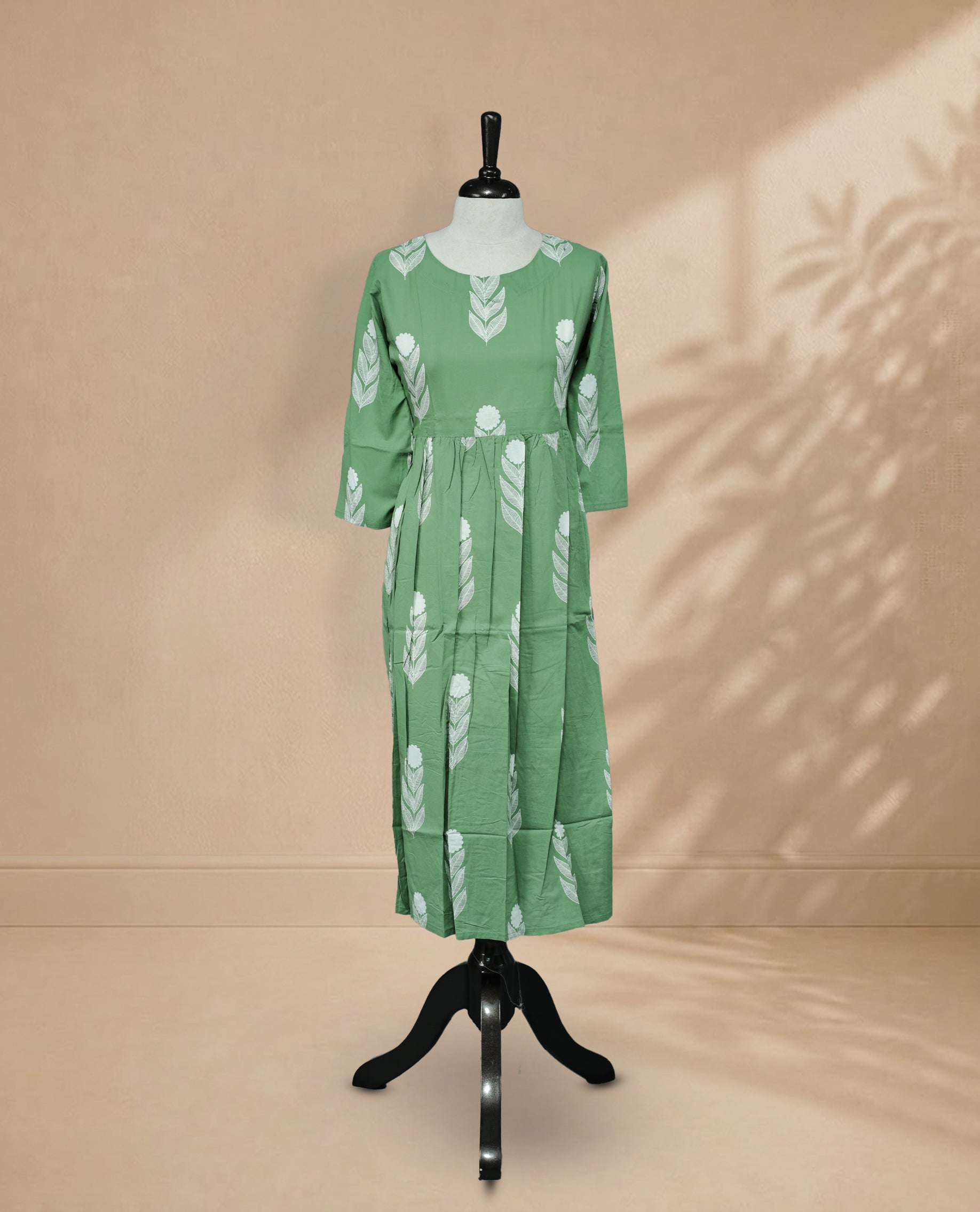 Pista Green Kurti featuring white digital Plant prints across the body, a round neckline, and a 3/4-sleeve design.