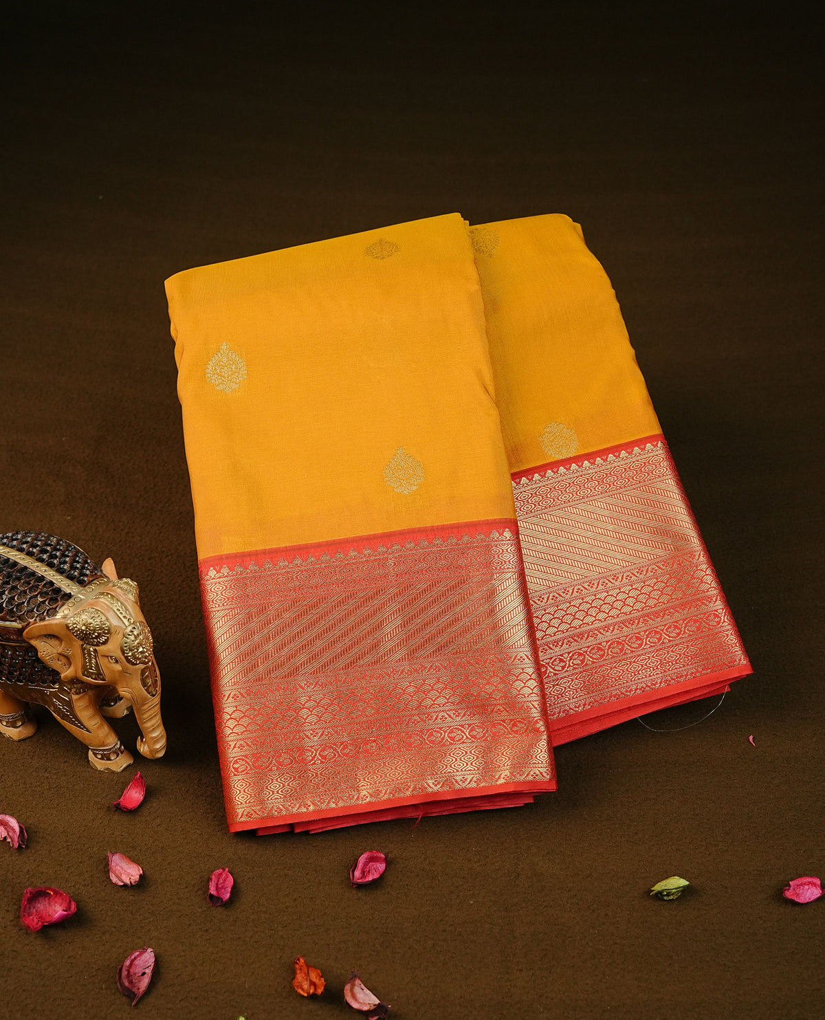 Mustard yellow colour semi wedding silk saree featuring gold zari with motifs on body,contrast red colour with traditional border on body,rich pallu comes with matching blouse piece
