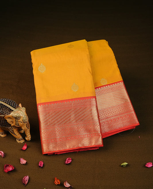 Mustard yellow colour semi wedding silk saree featuring gold zari with motifs on body,contrast red colour with traditional border on body,rich pallu comes with matching blouse piece