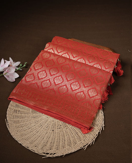 Red colour banaras satin crepe saree featuring gold zari pattern across body, with self colour border with gold zari pattern and paired with matching blouse.