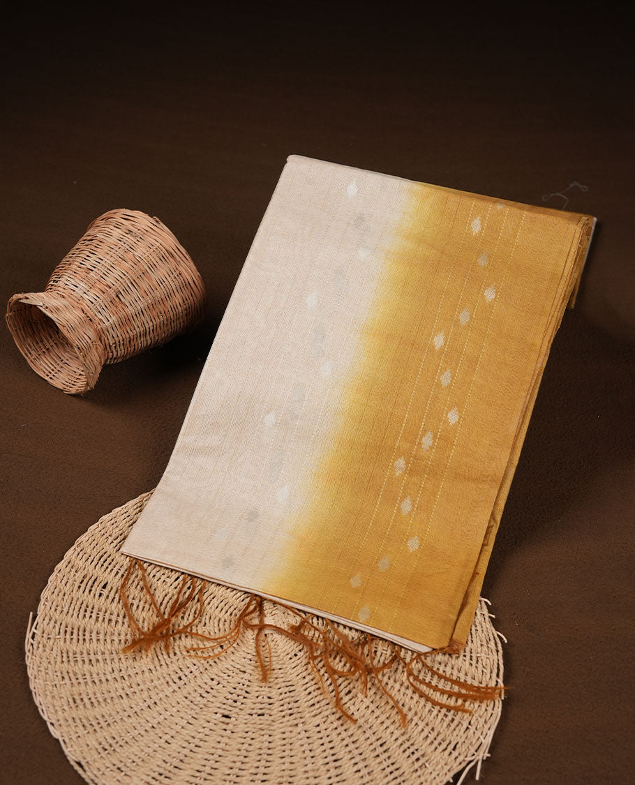 Cream & yellow dye pattern colour semi jute saree highlighting white stripped body, without border and paired with matching blouse.