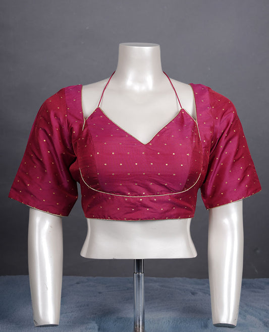 Rani pink colour padded blouse with gold polka dots, V neckline, elbow sleeves, and deep tie-up back.