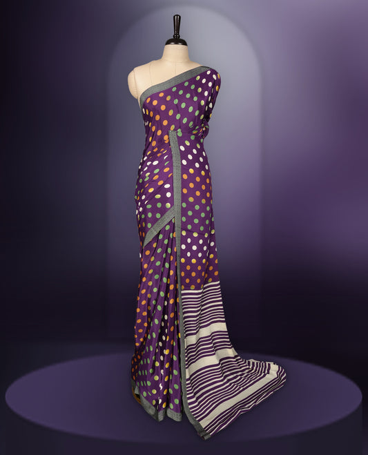 Purple colour saree with with large big polka dots on the body, self stripped pallu & Comes with a stylish matching blouse.