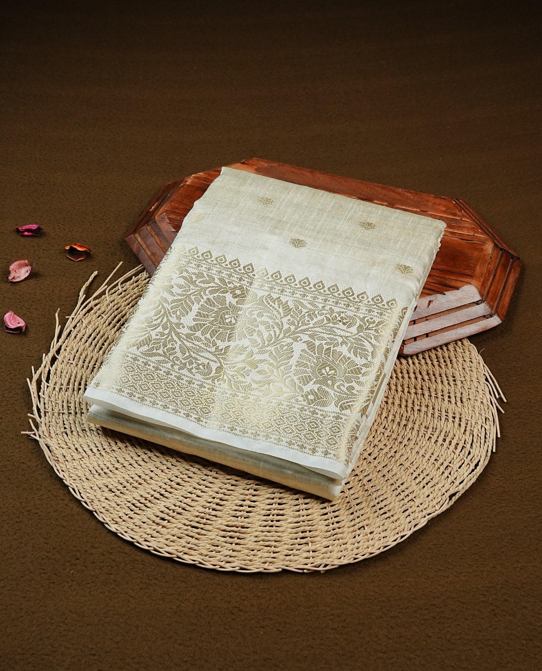 Off white gold Tussar saree featuring Gold zari buttas on body, complemented by self colour with traditional border, comes with matching blouse piece.