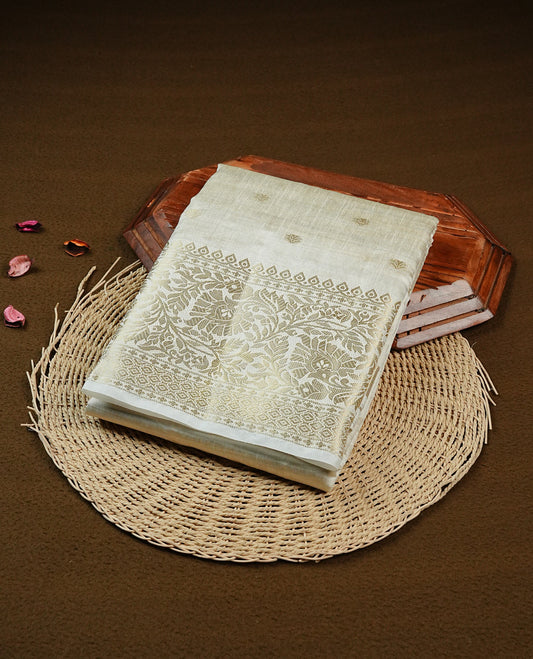 Off white gold Tussar saree featuring Gold zari buttas on body, complemented by self colour with traditional border, comes with matching blouse piece.