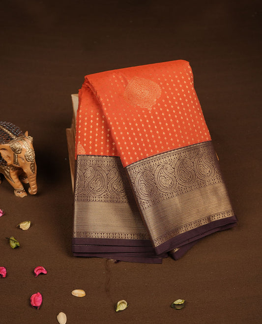 Rust orange colour semi silk saree featuring gold zari dotted stripes with motifs on body highlighting contrast dark chocolate gold zari mango border , paired with matching blouse