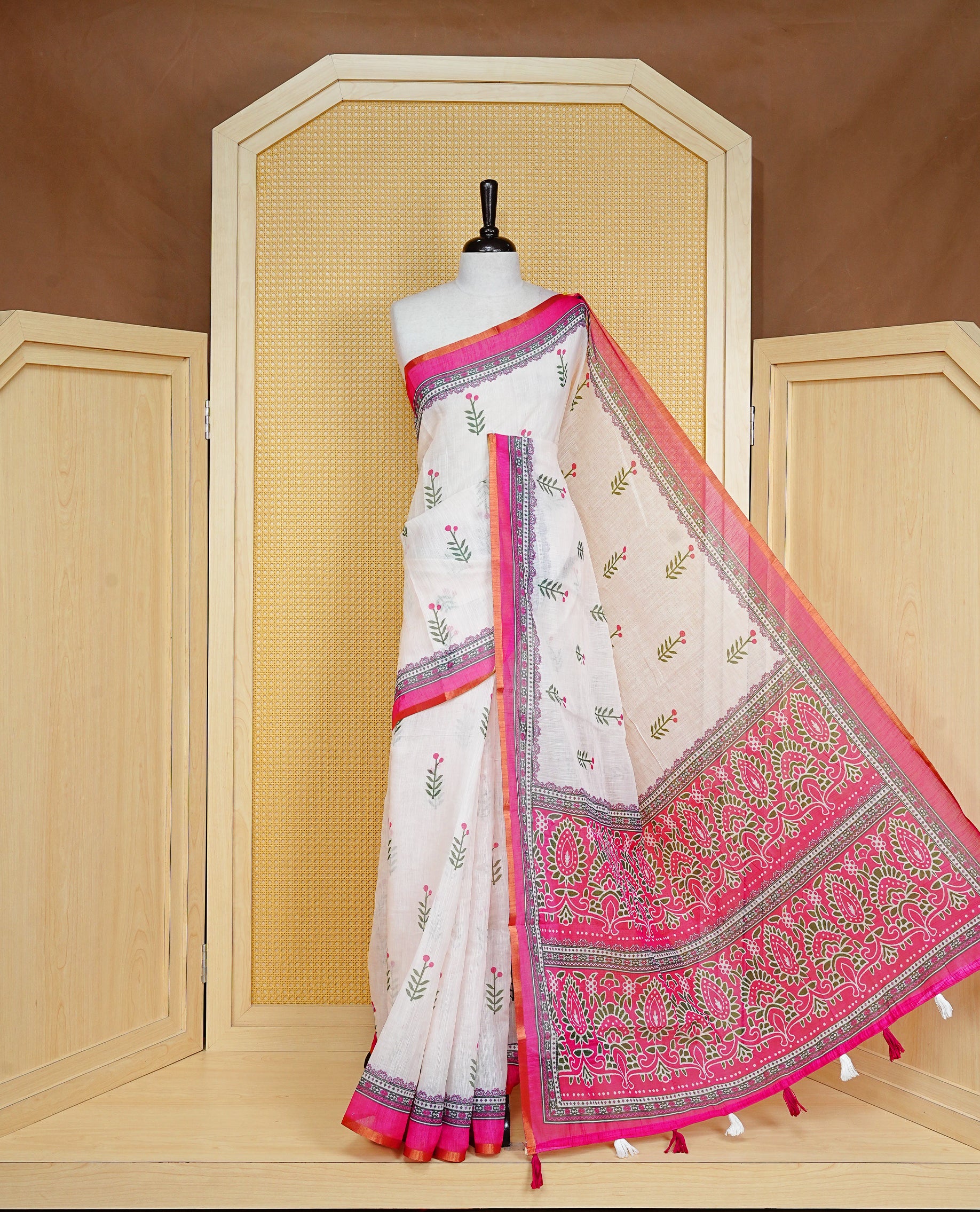 Off White colour Semi Linen Saree Featuring Elegant Floral Print on body, Contrast Pink Colour Border, Minimal Floral print Pallu, Unique Tassel Detailing For Festive Vibe, Contrast Colour Blouse piece.