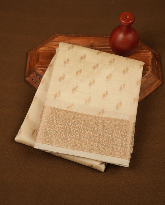 Cream colour tussar saree featuring litte gold zari motifs on body, Self colour border and pallu with zari woven design, comes with matching blouse piece.