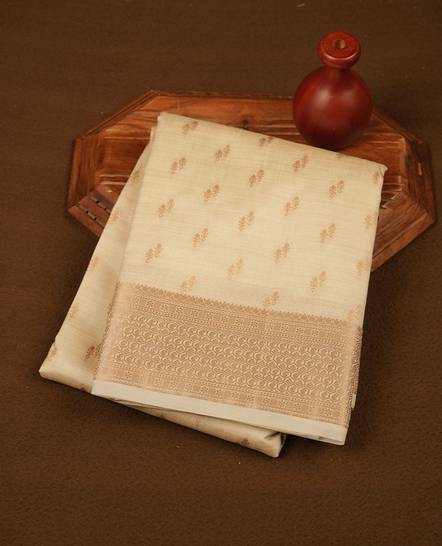 Cream colour tussar saree featuring litte gold zari motifs on body, Self colour border and pallu with zari woven design, comes with matching blouse piece.
