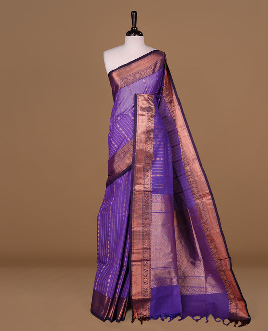Violet Colour Chettinad cotton saree featuring Gold zari Stripes on body, complemented by contrast Dark purple colour with traditional border, paired with matching blouse piece.