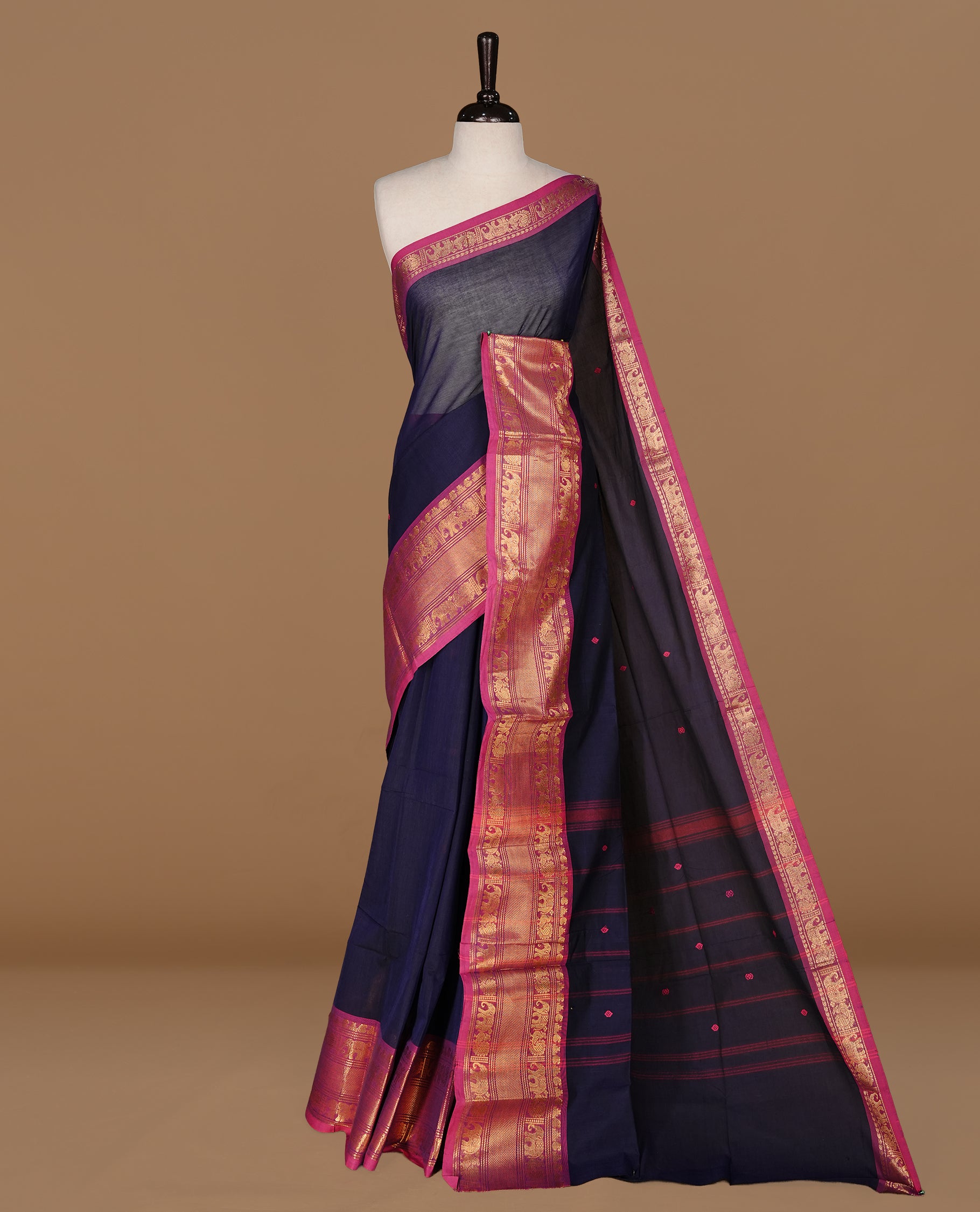 Navy Blue colour Chettinad cotton saree featuring motifs on body , complemented by contrast Magenta colour with zari border, comes with matching blouse piece.