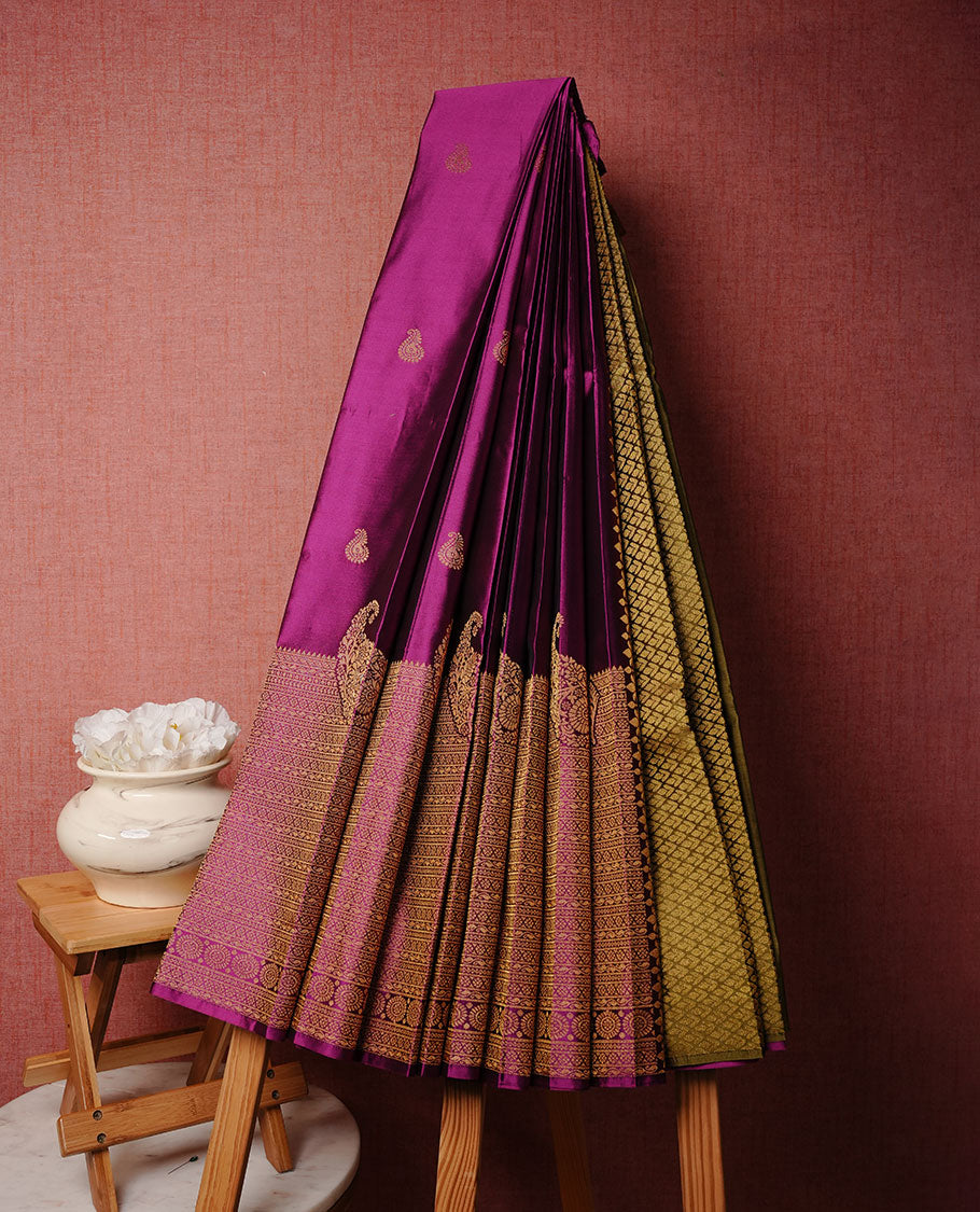 Magenta colour soft silk sareee featuring gold zari Motifs on body, complemented by self colour with zari border, paired with contrast colour blouse piece.