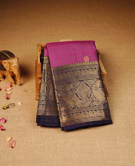 Purple colour Kancheepuram silk saree featuring Gold zari thin Stripes & Motifs on body, Highlighting Violet colour with Gold Zari border, paired with matching blouse piece.
