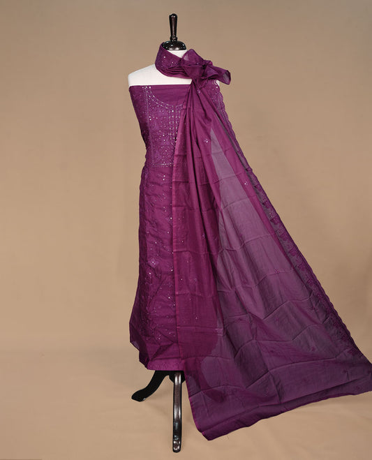 Wine colour churidar material featuring self colour thread and sequins on body and neckline, paired with matching bottom and dupatta