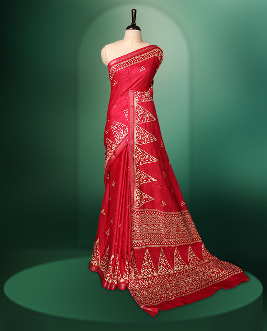 Red Colour saree featuring bold geometric and ethnic inspired prints all over the body, enhanced with a matching printed border, complemented by a striking patterned pallu, and paired with a matching blouse
