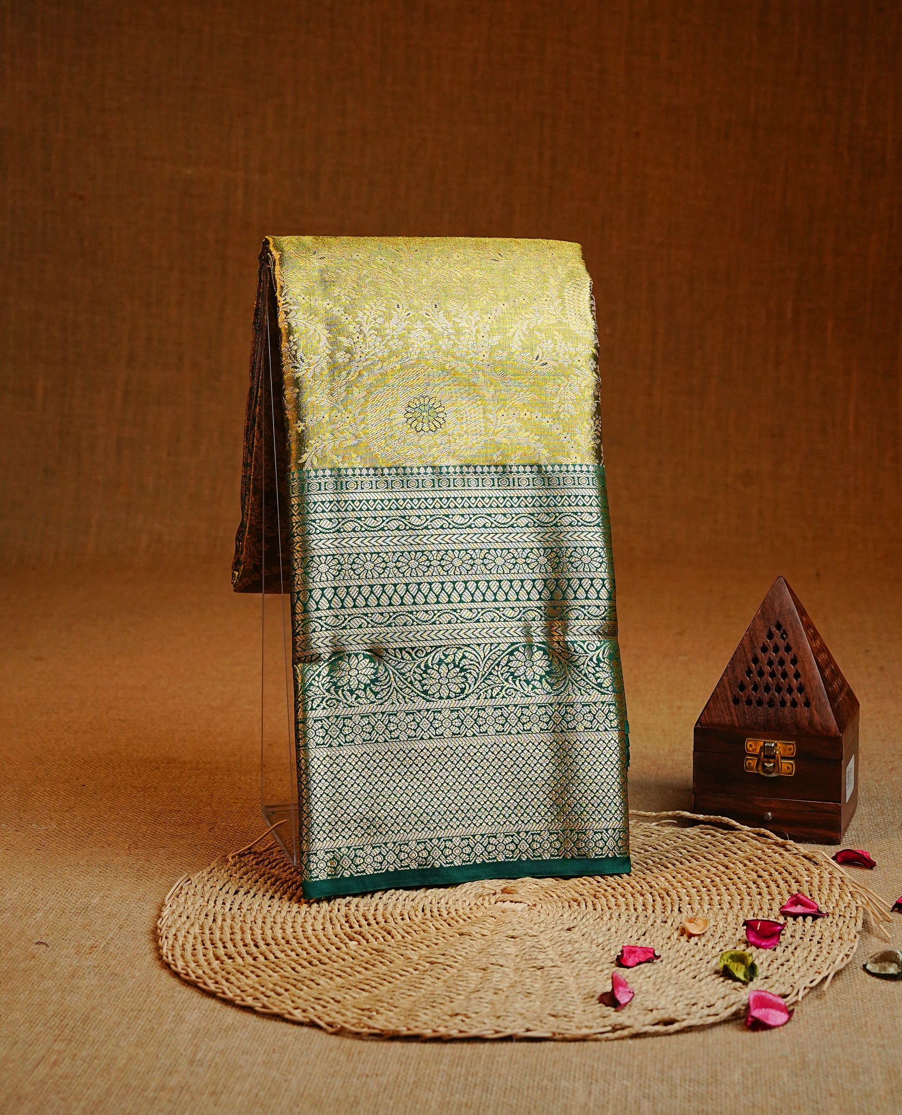Light green & gold colour Double shade Semi tissue silk saree featuring self color floral kodi Pattern on body, Contrast Green colour with traditional border, paired with matching.