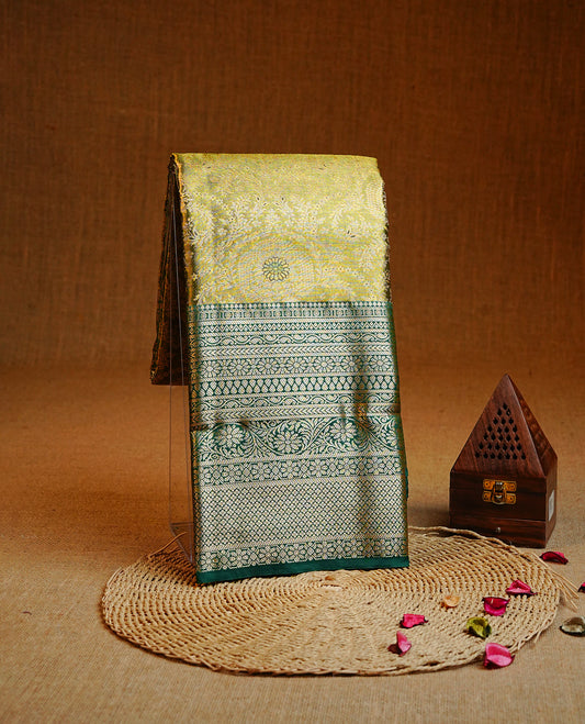 Light green & gold colour Double shade Semi tissue silk saree featuring self color floral kodi Pattern on body, Contrast Green colour with traditional border, paired with matching.
