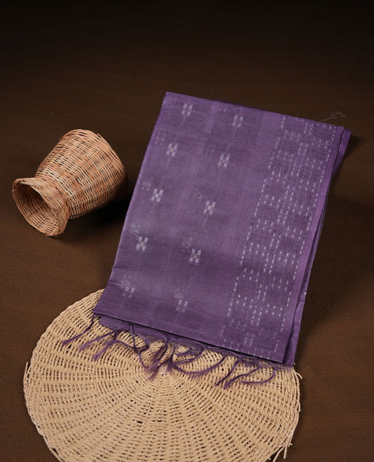 Blue lilac colour semi jute saree highlighting white thread motifs on body, without border and paired with matching blouse.