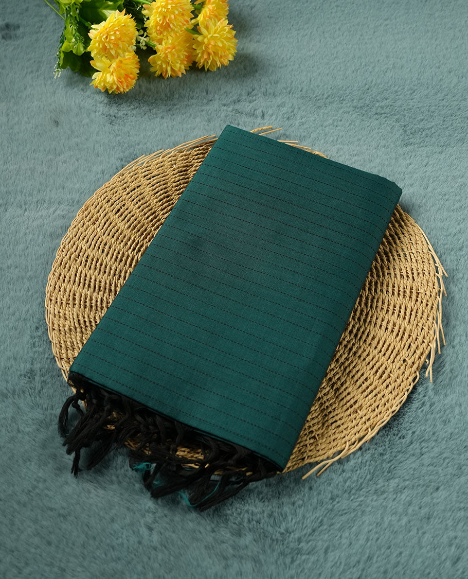 Dark Teal Green colour poly cotton saree with black vertical dotted line pattern on the body, paired with a matching pallu featuring black zigzag geometric border, and a coordinated all‑over black stylised fleur‑de‑lis printed blouse piece.