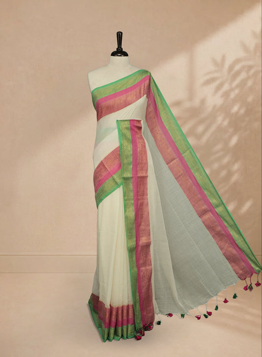Off white Colour Mul Cotton saree featuring Elegant plain body, contrast Green & Pink colour with gold zari traditional border.