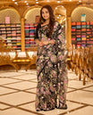 Elegant black net designer saree richly adorned with heavy bead and sequin work in pastel floral motifs, featuring a sheer drape that adds charm, paired with a matching embellished blouse.