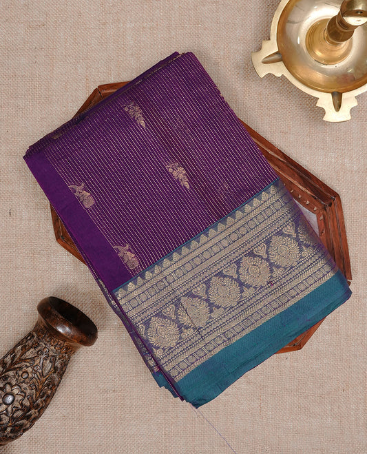 Purple colour chettinad cotton saree featuring gold zari stripes & motifs on body, complemented by Contrast Green colour with zari border, paired with matching blouse piece.