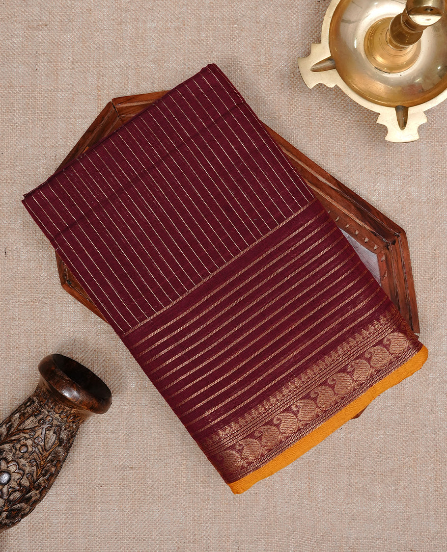 Maroon colour Chettinad cotton saree featuring Gold zari stripes on body, complemented by Self colour with Gold zari border mustard piping, paired with matching blouse piece.
